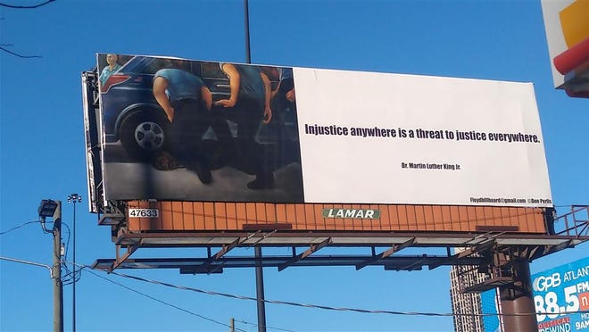 The George Floyd Justice Billboard Committee has placed billboards featuring an artist rendering of George Floyd's death and a quote from Dr.  Martin Luther King Jr. was included in major cities across the United States, including this one in Atlanta.