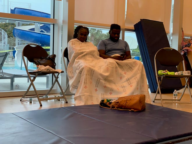 The American Red Cross established a reunion site for family and friends near the site of the partial collapse of a 12-story condominium in Surfside, Florida, early Thursday, June 24, 2021.  About 70 people crowded into a room with chairs and blue exercise mats on the floor.