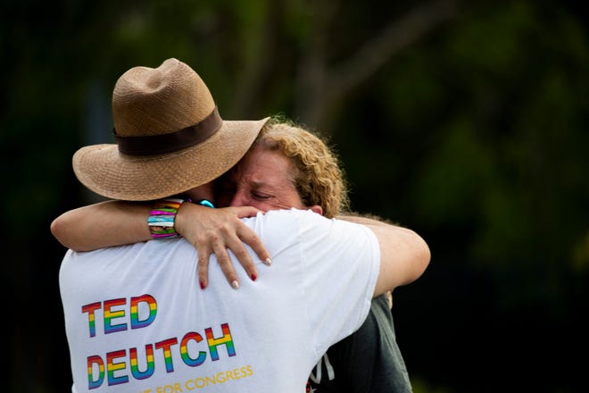 United States MPs Debbie Wasserman Schultz and Ted Deutch embrace after a truck crashes into a crowd during a Pride parade at Wilton Manors, near Fort Lauderdale on Saturday.