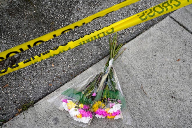 Flowers lie at the scene where a driver crashed into spectators at the start of a Pride parade Saturday night, killing one man and seriously injuring another, Sunday June 20, 2021 in Fort Lauderdale, Fla.  Officials said the crash was an accident.  But it initially drew speculation that it was a hate crime against the gay community.  The driver and victim were all members of the Fort Lauderdale Gay Men's Chorus who attended the Wilton Manors Stonewall Pride Parade.