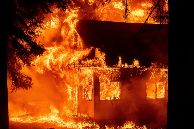 Flames devour a home as the Dixie Fire ripped through the Indian Falls community in Plumas County, California on Saturday, July 24, 2021.