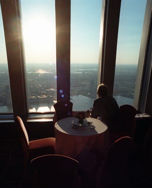 An unidentified patron looks at the 50-mile view from the Windows on the World restaurant atop tower 1 of the World Trade Center in New York Wednesday, June 26, 1996.
