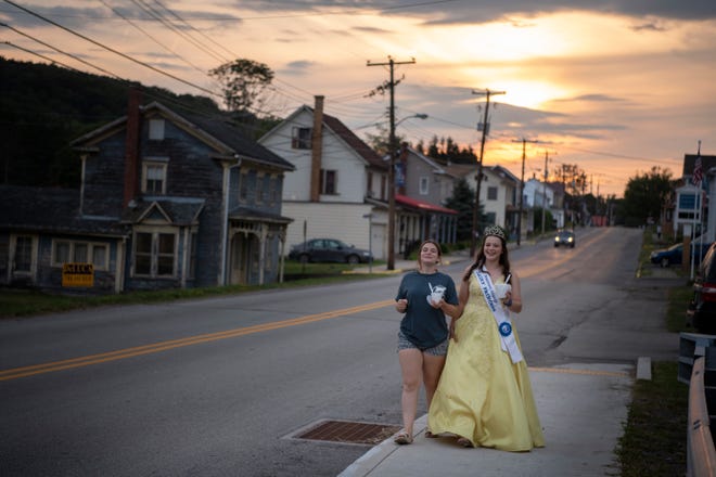 (Right) Kaitlyn Stoltzfus, Somerset County Dairy Princess, and her sister Abby, on Main Street in Shanksville, Pennsylvania, on Friday, August 6, 2021.